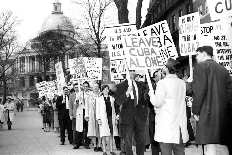Young Americans protest U.S. policies toward Cuba in an old black and white photo.