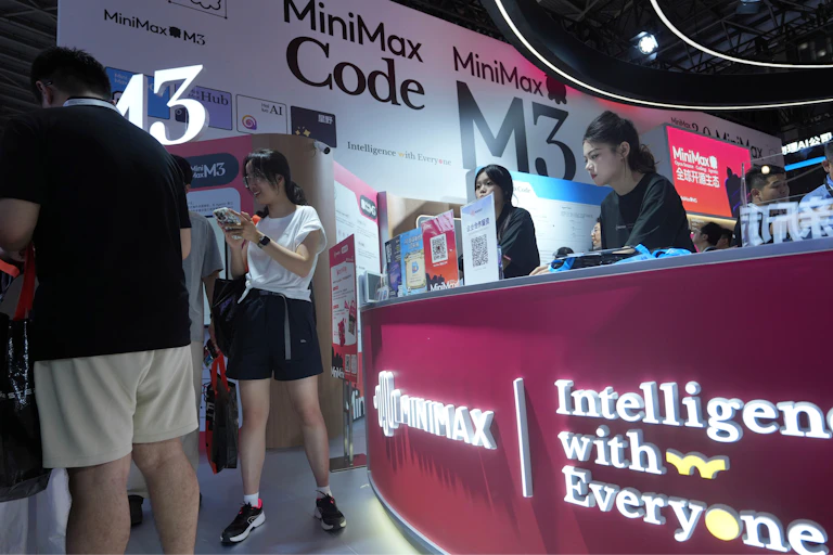people behind and in front of a booth at a trade show