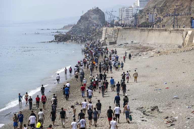 View from above of people walking along a beach