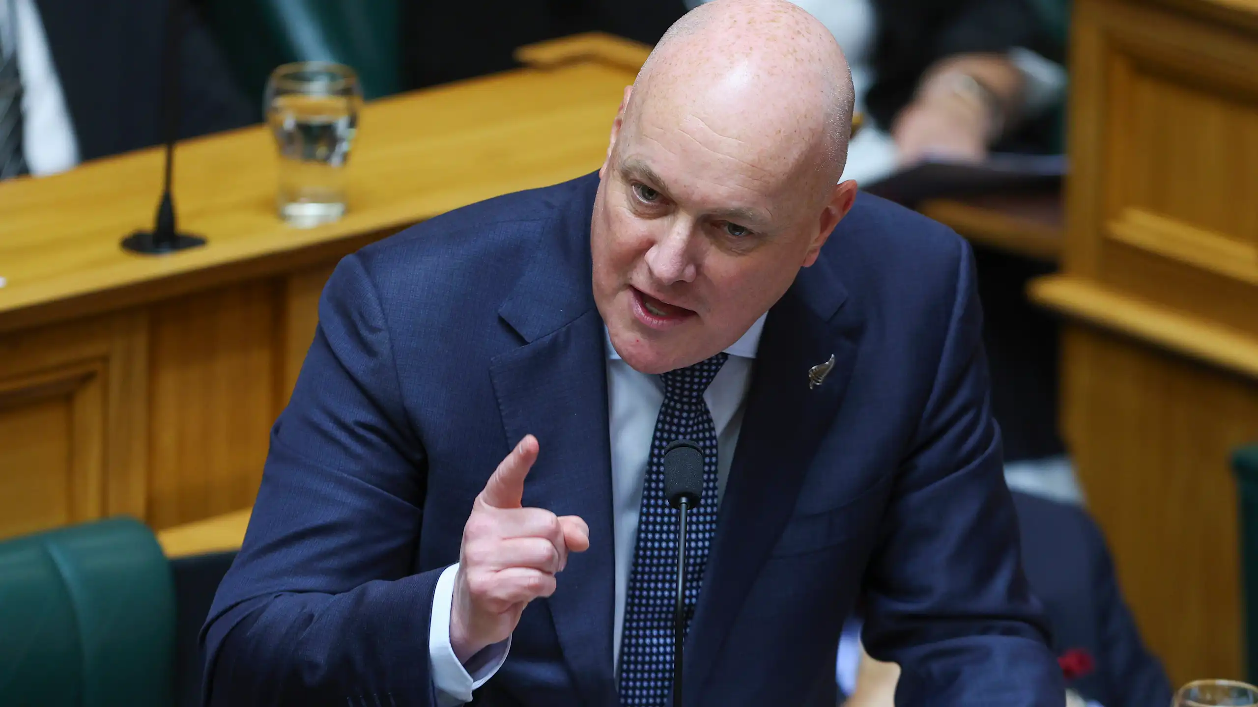 Christopher Luxon speaking in parliament and gesturing with hand