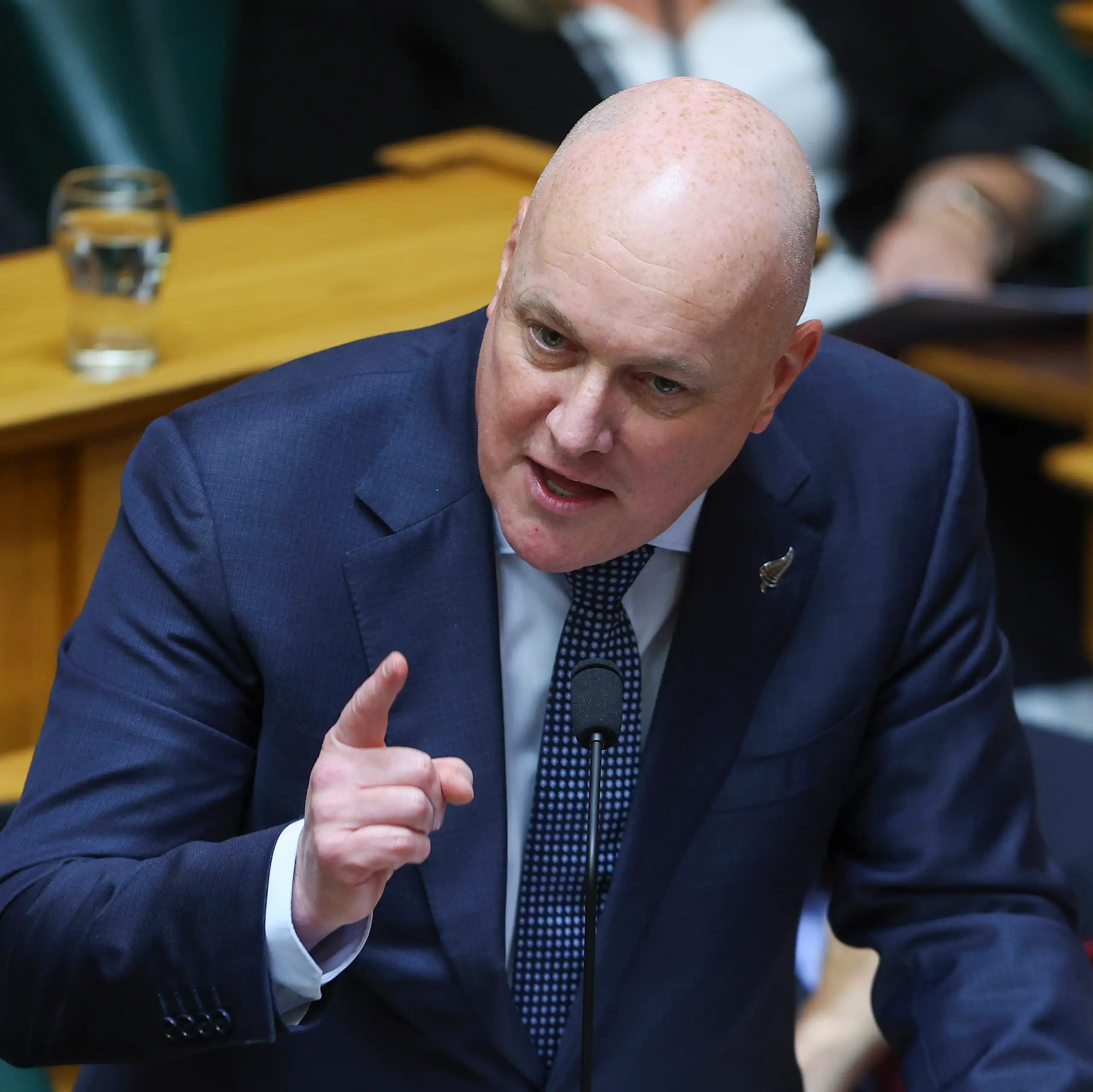 Christopher Luxon speaking in parliament and gesturing with hand