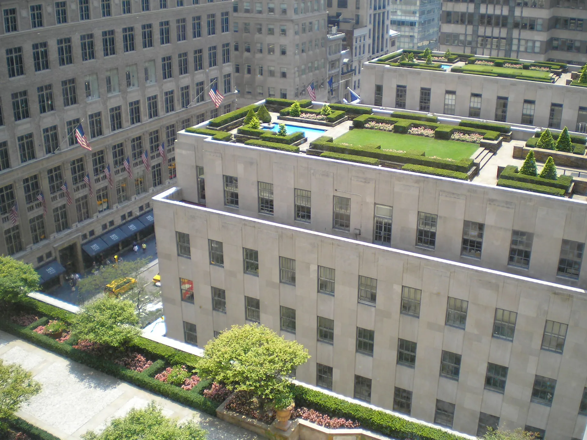 Three rooftops with green lawns and wide walking paths.