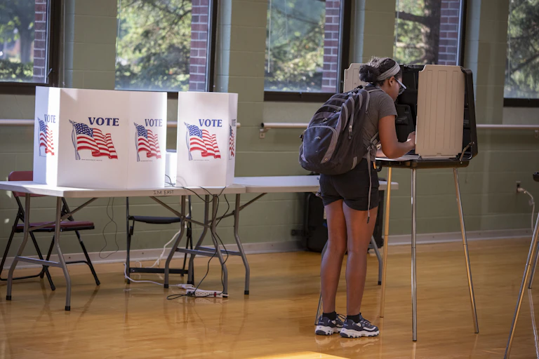 Female voter fills out ballot