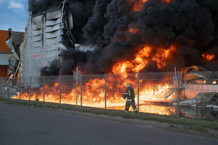 A firman at a blaze in a Wilberries warehouse in the Utkina Zavod area, Russia, July 24 2026.