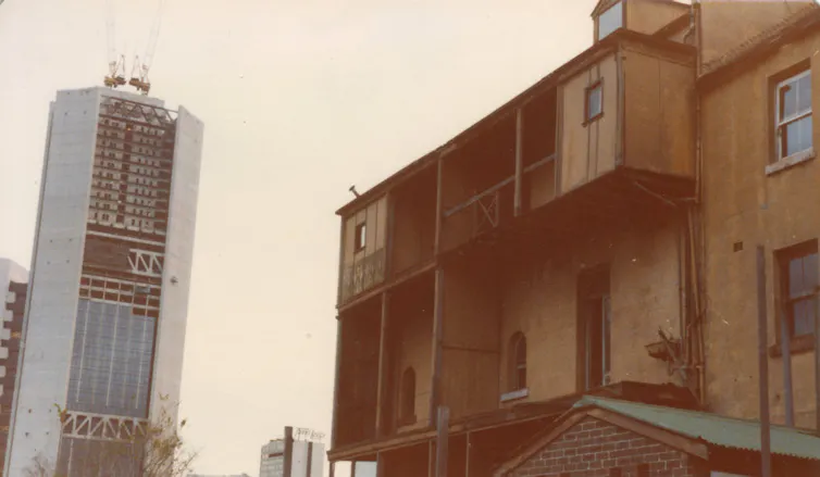 View showing derelict houses & the Qantas Tower, on Lang Street, under construction.