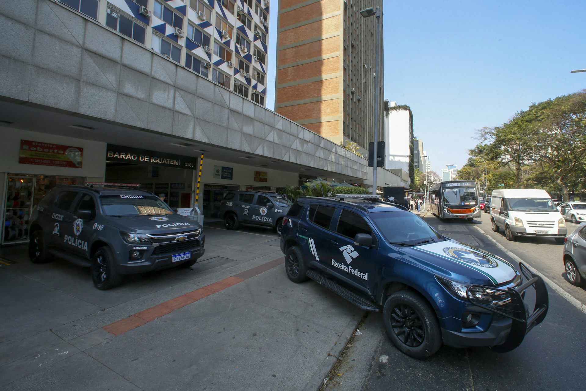 Police cars park outside a building