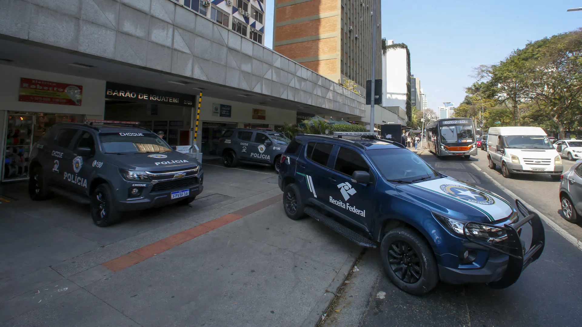 Police cars park outside a building