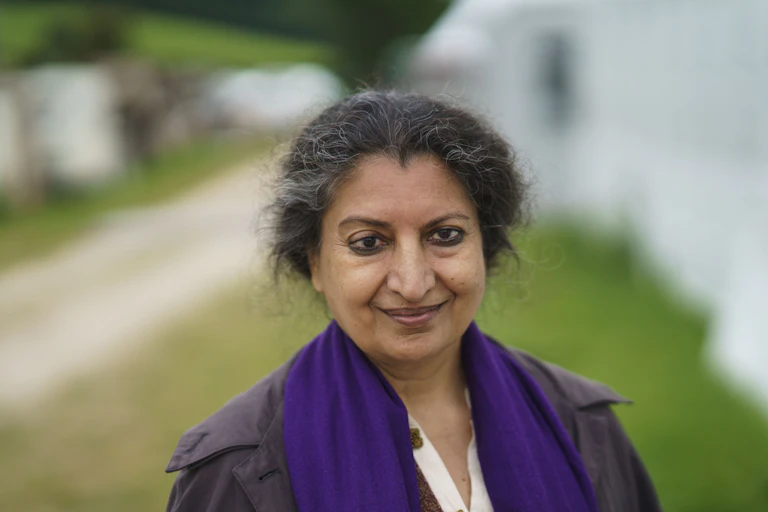 Closeup of Geetanjali Shree outdoors, wearing a purple scarf