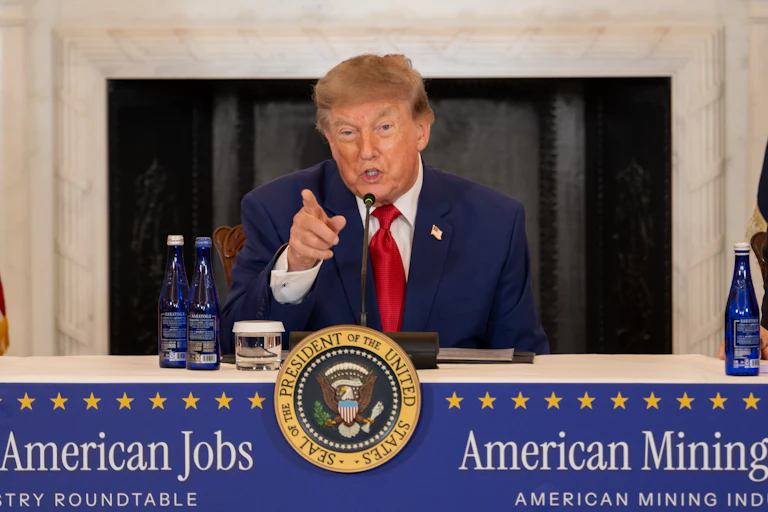 US President Donald Trump speaks into a microphone