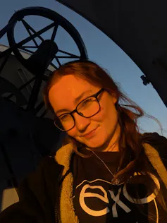 Woman standing outside telescope building
