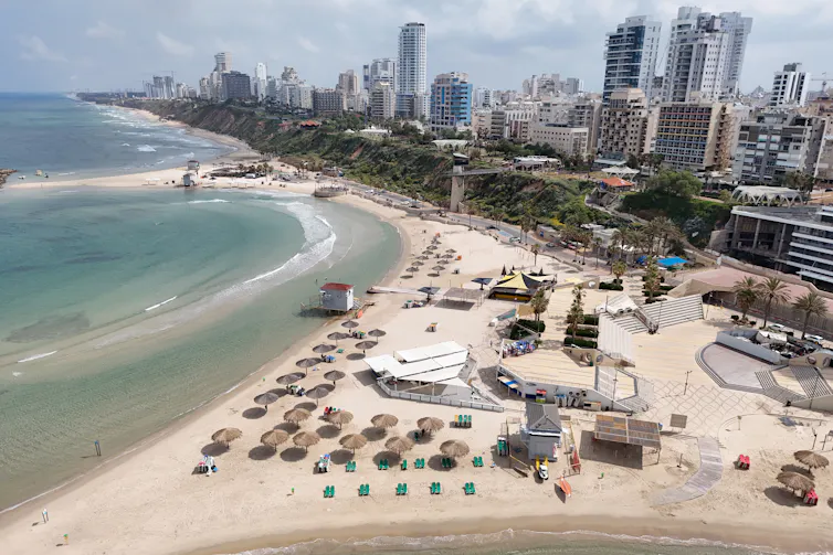 A beachfront city has some tall buildings.