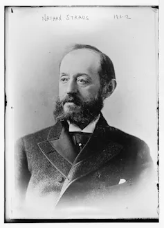 This black and white photo is a portrait of a man in an old-fashioned suit.