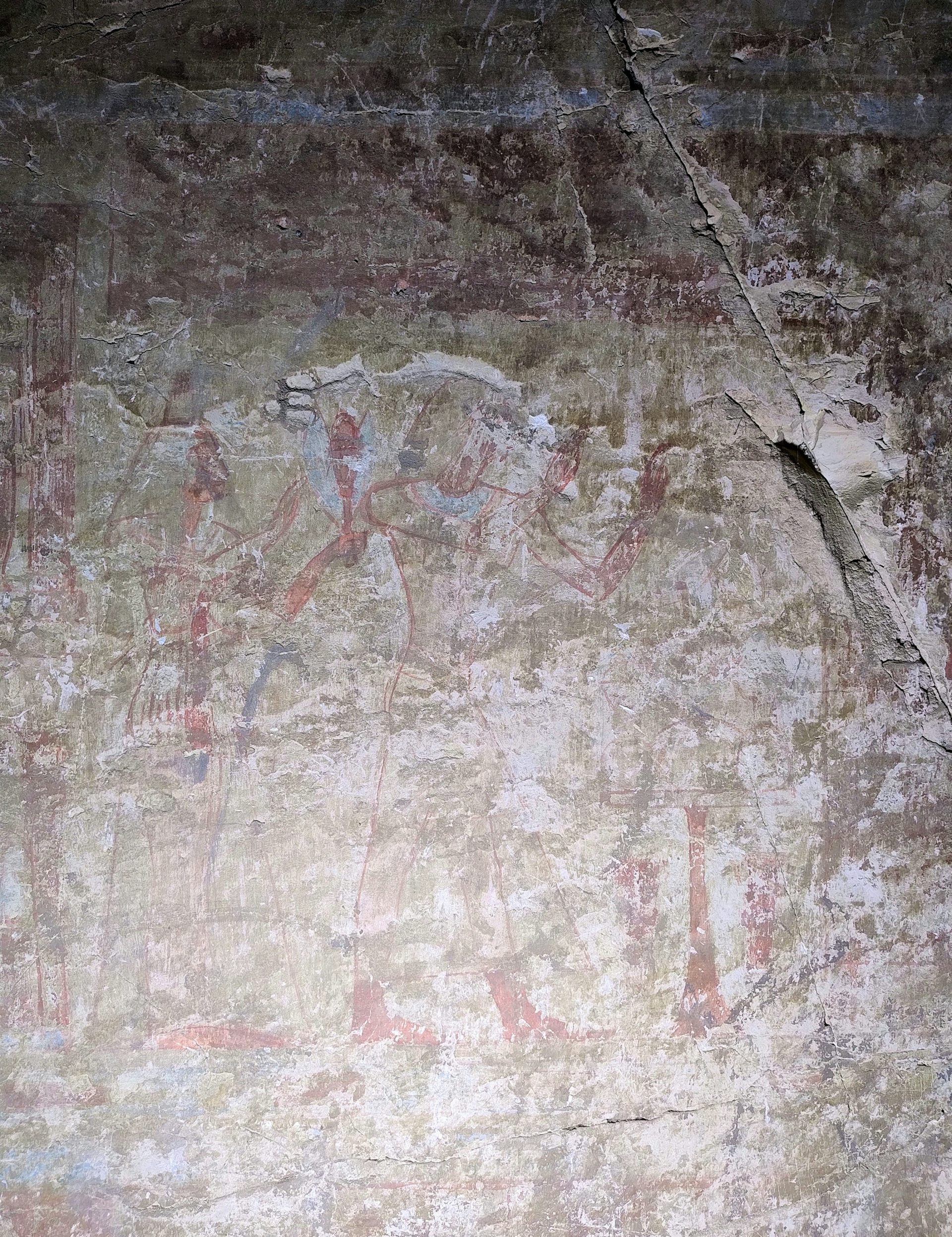 The walls of the rock-cut chapel are decorated with vivid red-coloured wall paintings.