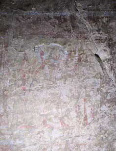 The walls of the rock-cut chapel are decorated with vivid red-coloured wall paintings.