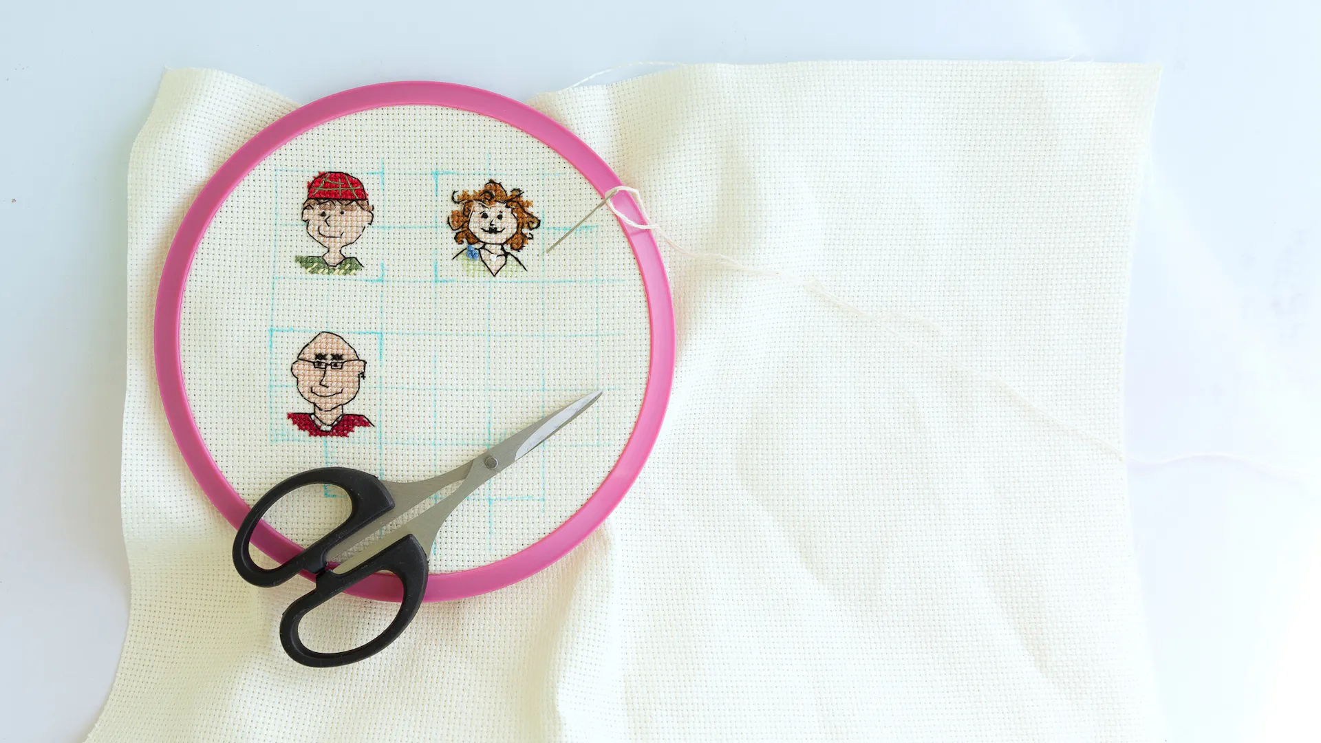 A cross-stitch featuring mini portraits of three adults.
