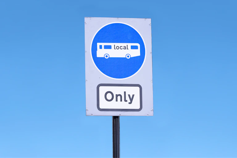 blue sky, blue roadsign buses only