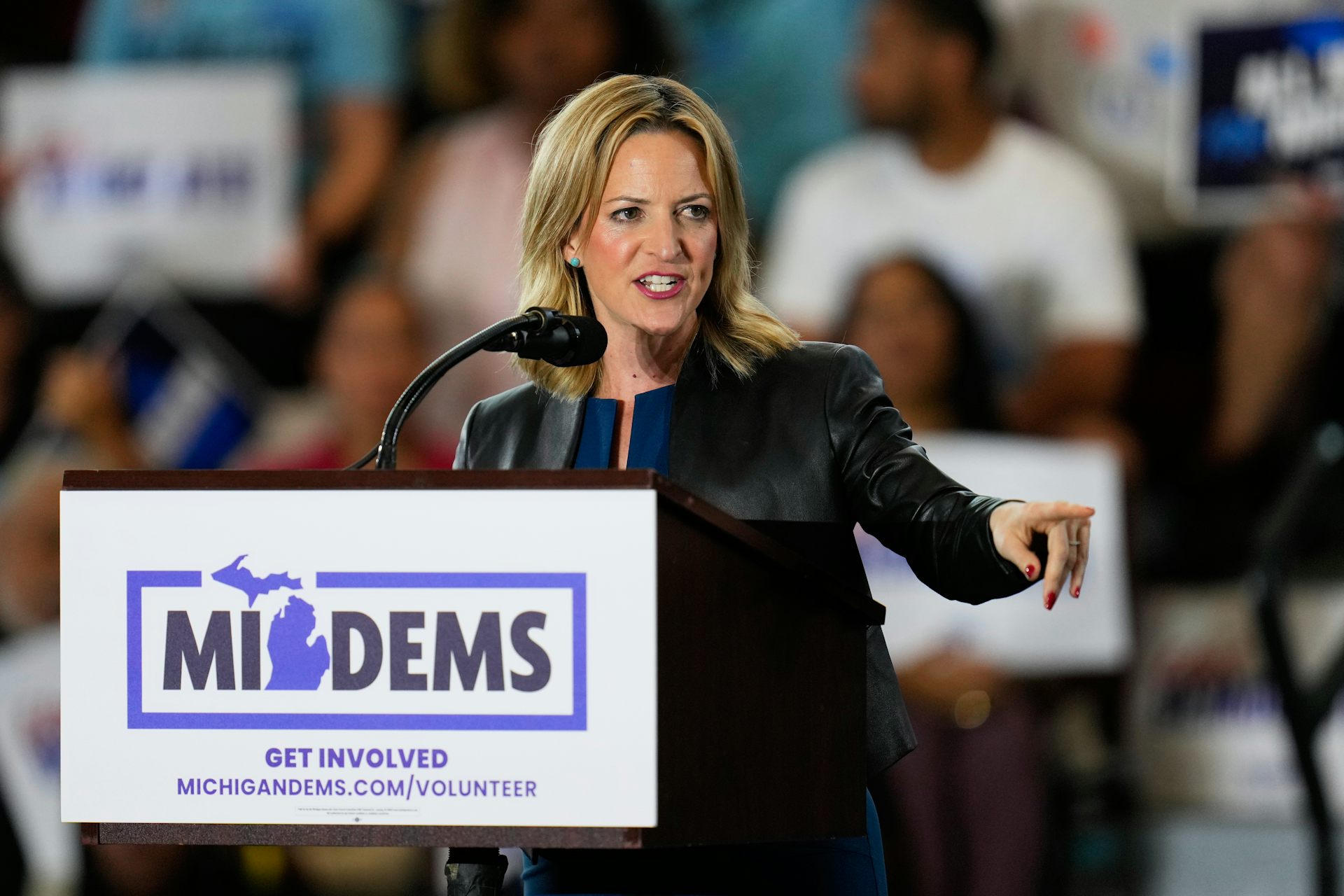 Woman stands behind podium