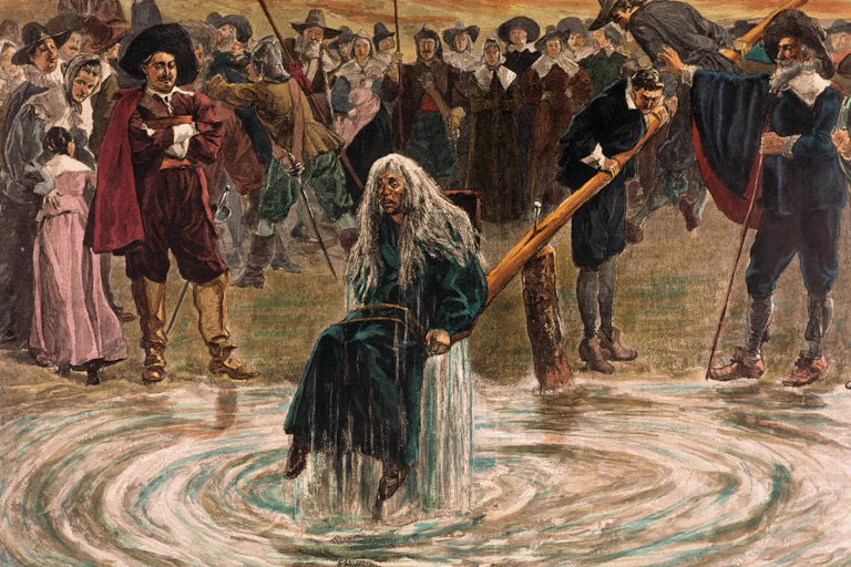 An accused witch going through the judgement trial, where she is dunked in water to prove her guilt of practicing witchcraft.