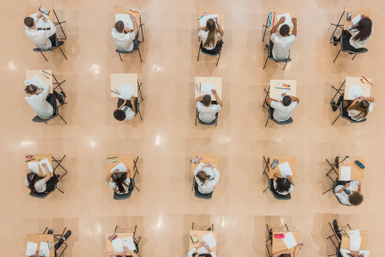Drone image directly above twenty high school students sitting an exam.
