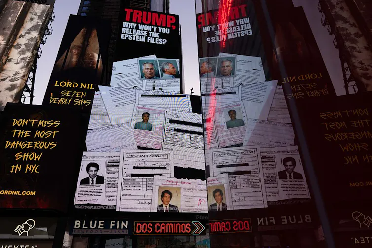 A billboard in a city center shows several photographs of police files.