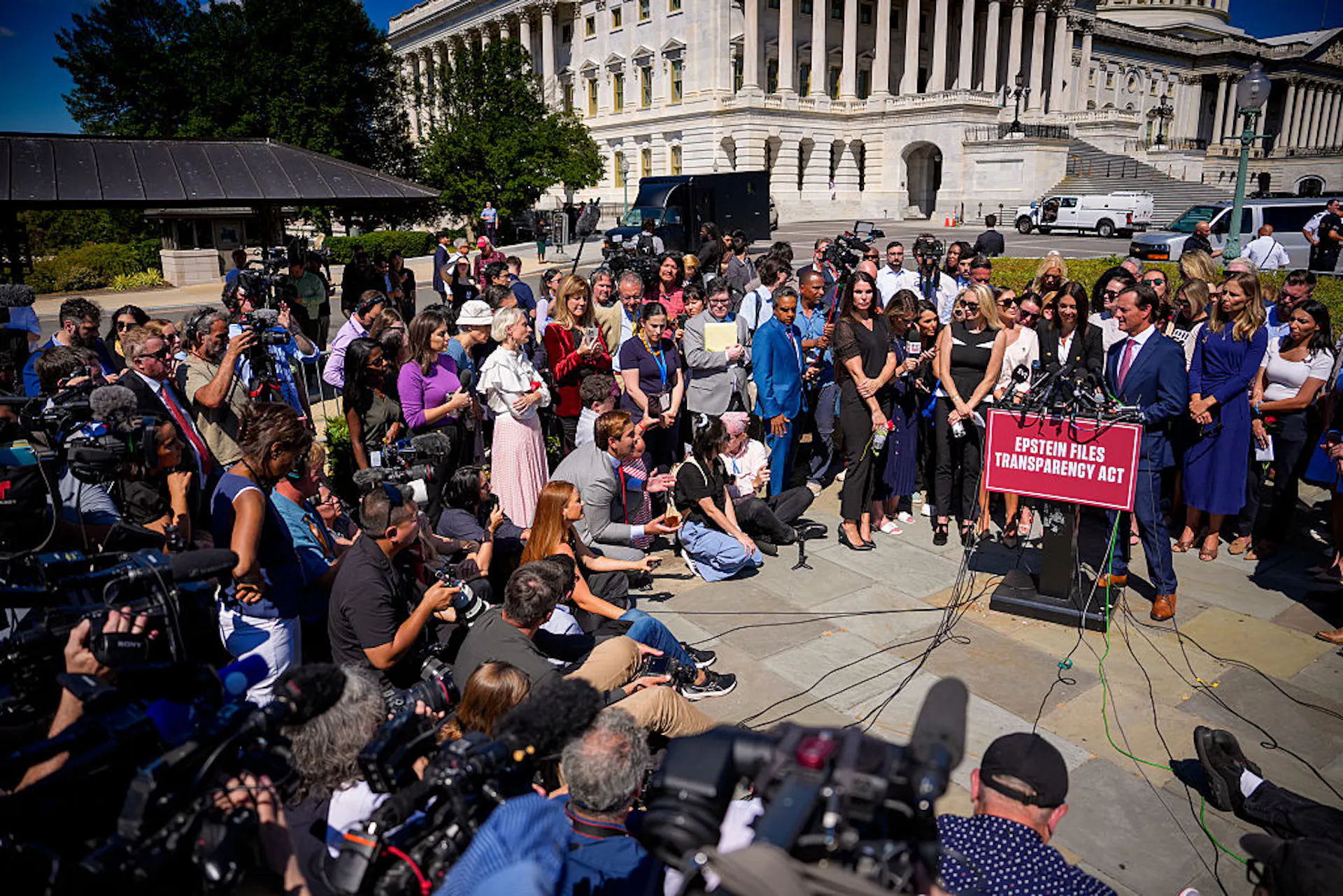 A man speaks to a large crowd outside a federal building.
