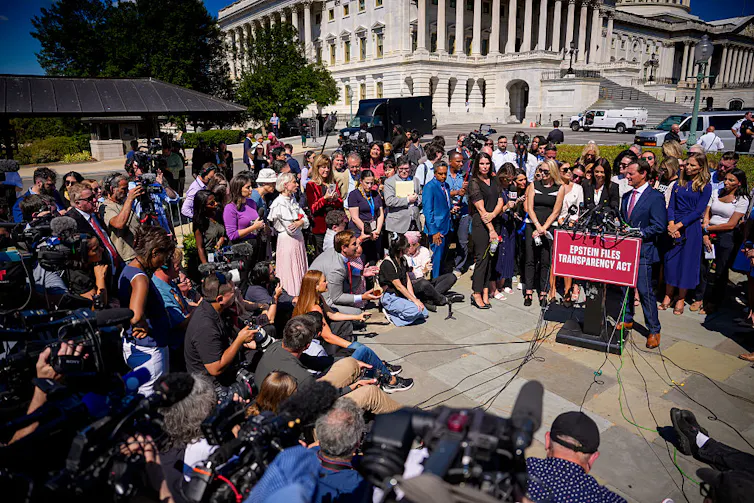 A man speaks to a large crowd outside a federal building.