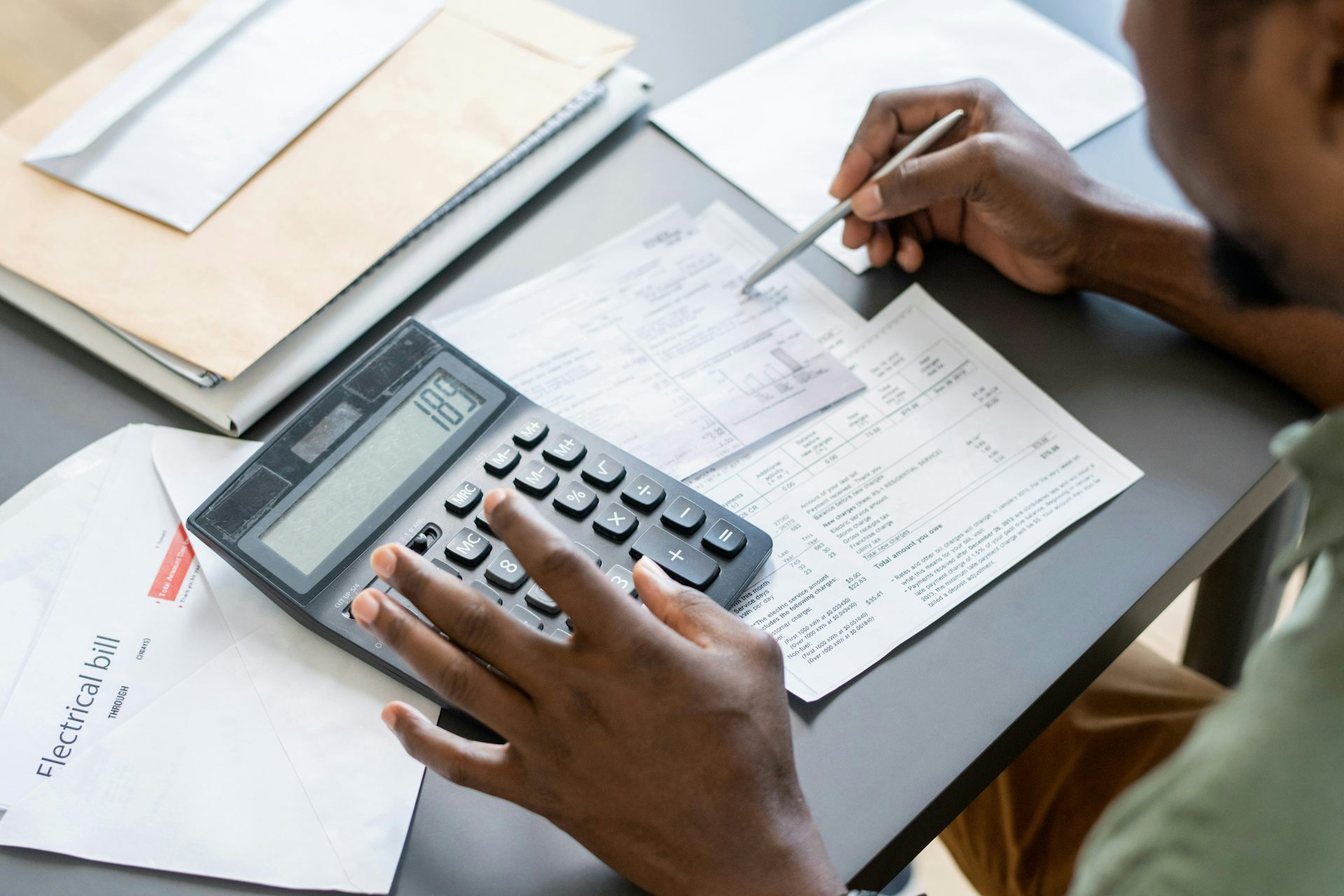 A person sorts through bills and financial documents