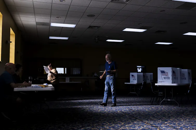 Man stands holding paper