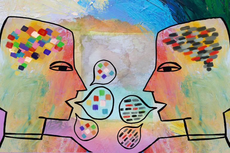 Two heads with colourful speech bubbles.