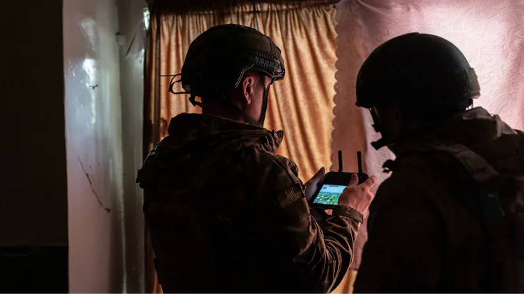 Ukrainian military personnel operate a drone from an undisclosed location.