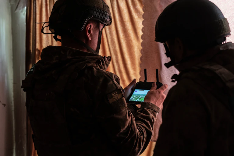 Ukrainian military personnel operate a drone from an undisclosed location.