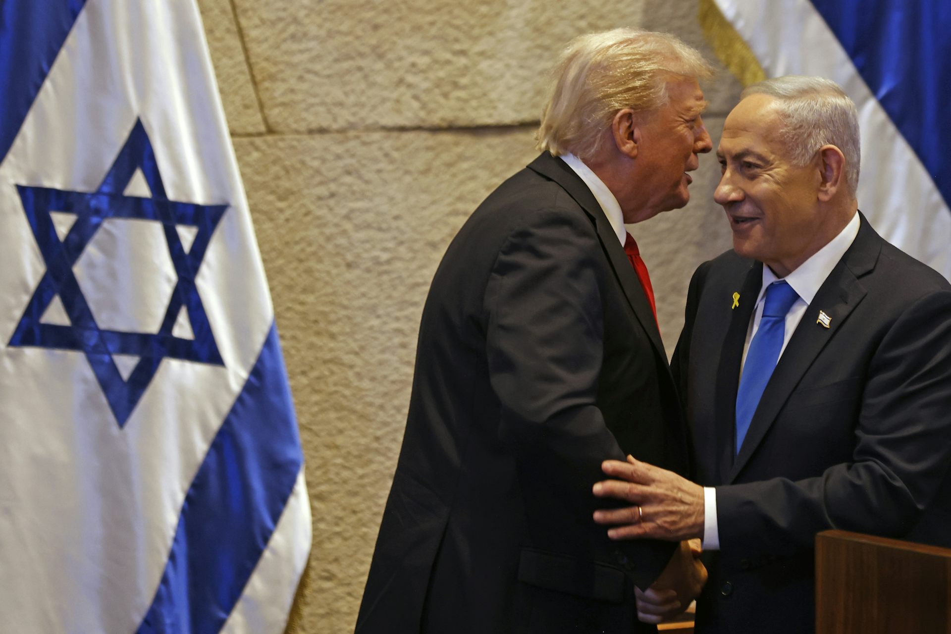 Donald Trump and Benjamin Netanyahu embrace.