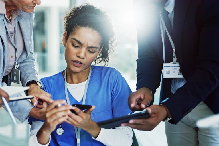 Nurse multitasks while colleagues show fight for her attention
