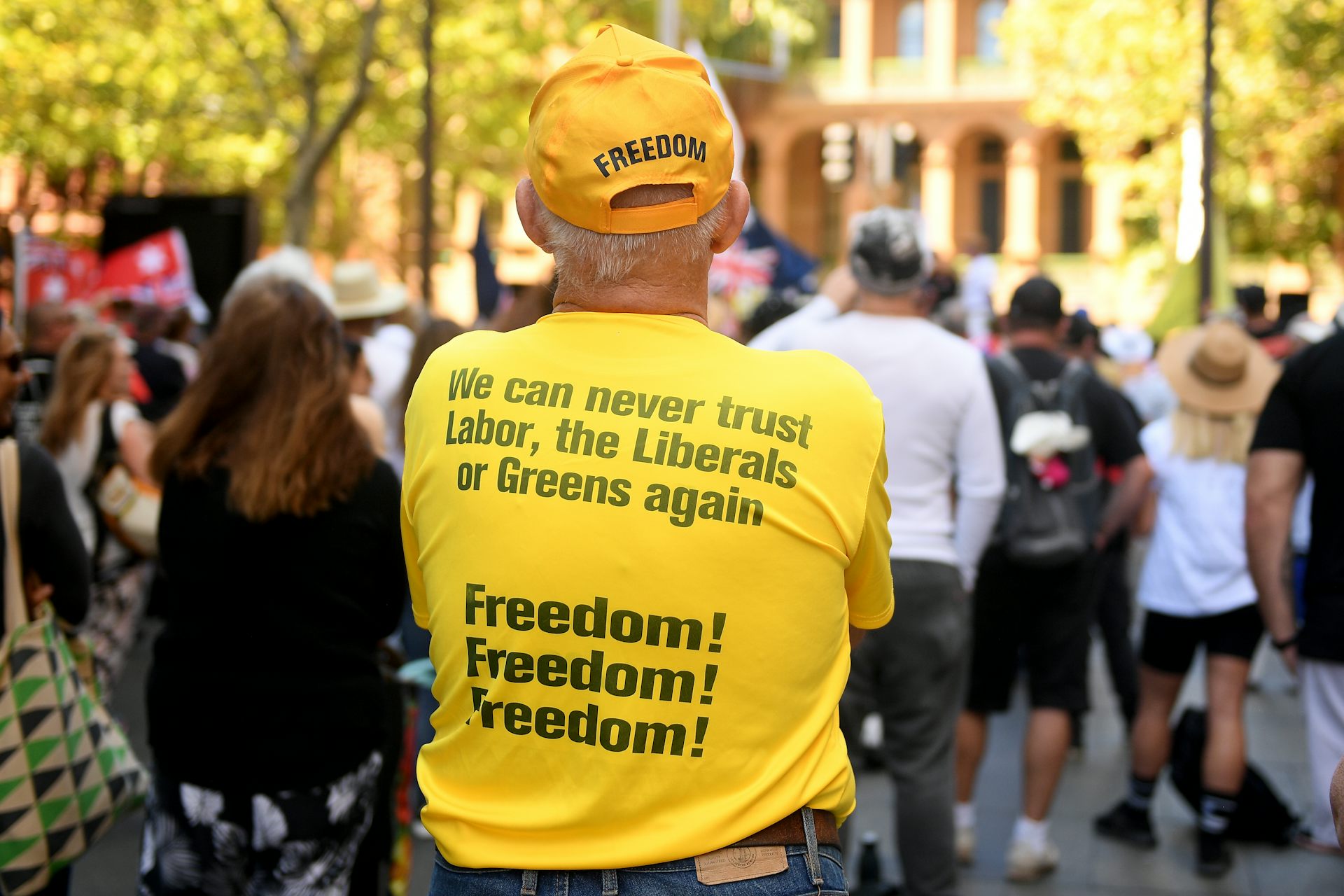 man in yellow t-shirt decrying all major parties