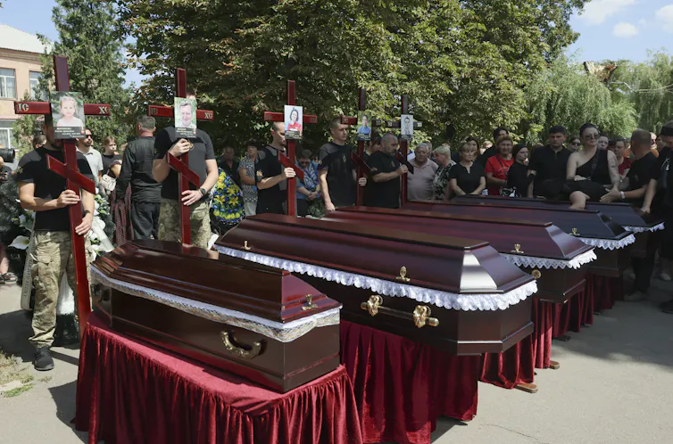 Mourners with the coffins of five Ukrainian victims of a Russian missile attack.