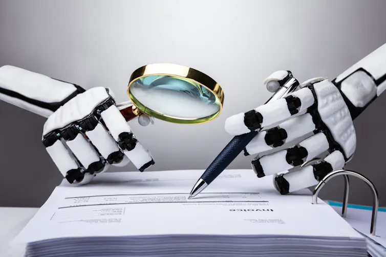 two robot hands, one holding a magnifying glass and the other a pen, over a paper document