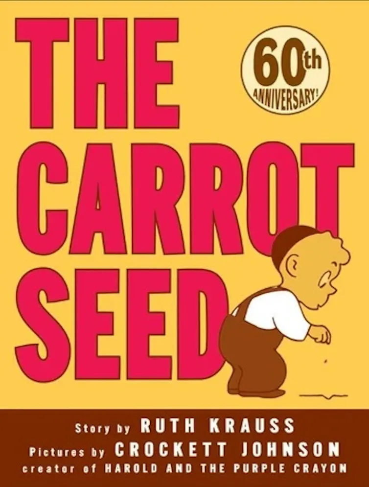 A yellow book cover says 'The Carrot Seed' and shows a cartoon drawing of a young child bending over.
