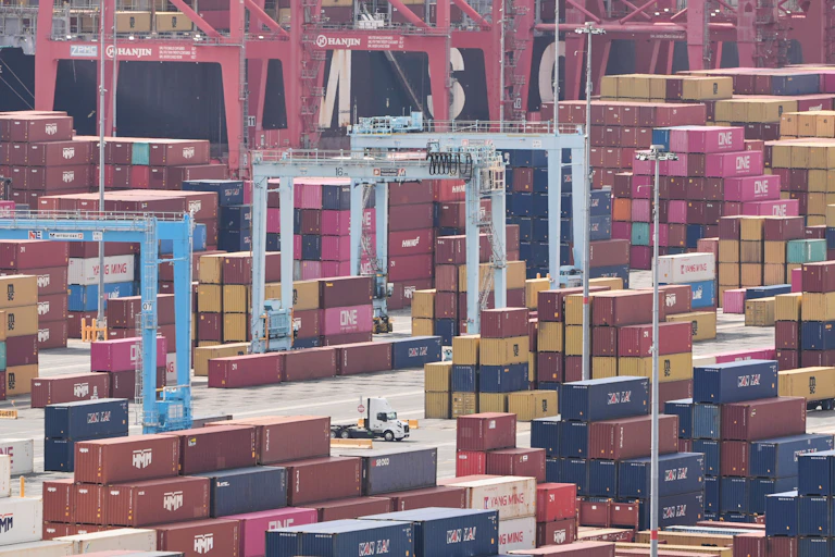Multi-hued shipping containers are stacked at the Port of Long Beach, Calif.
