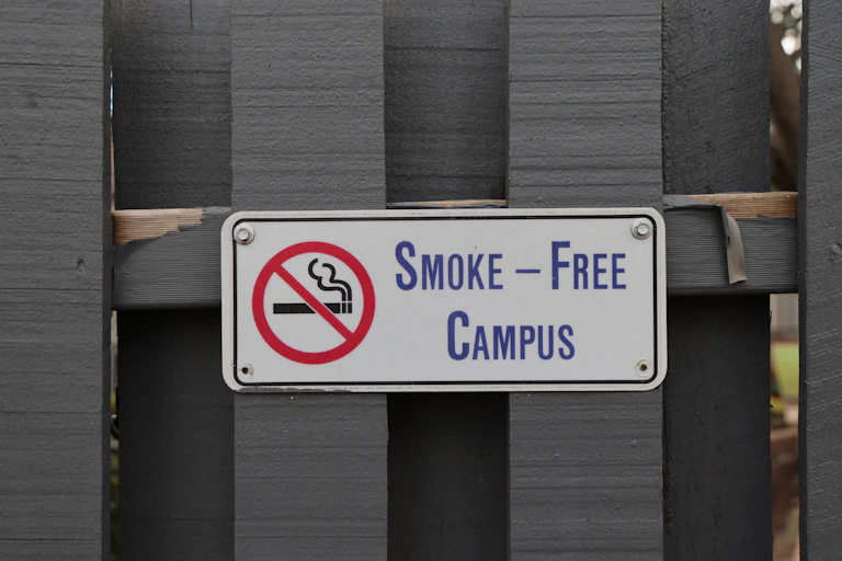 Smoke-free campus sign posted on a school fence