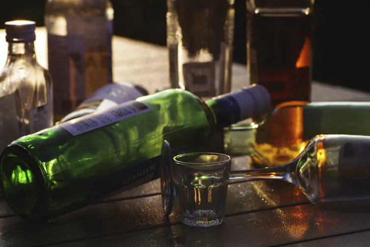Array of empty alcohol bottles and glasses