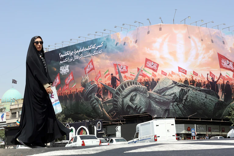 Woman walking in front of a billboard
