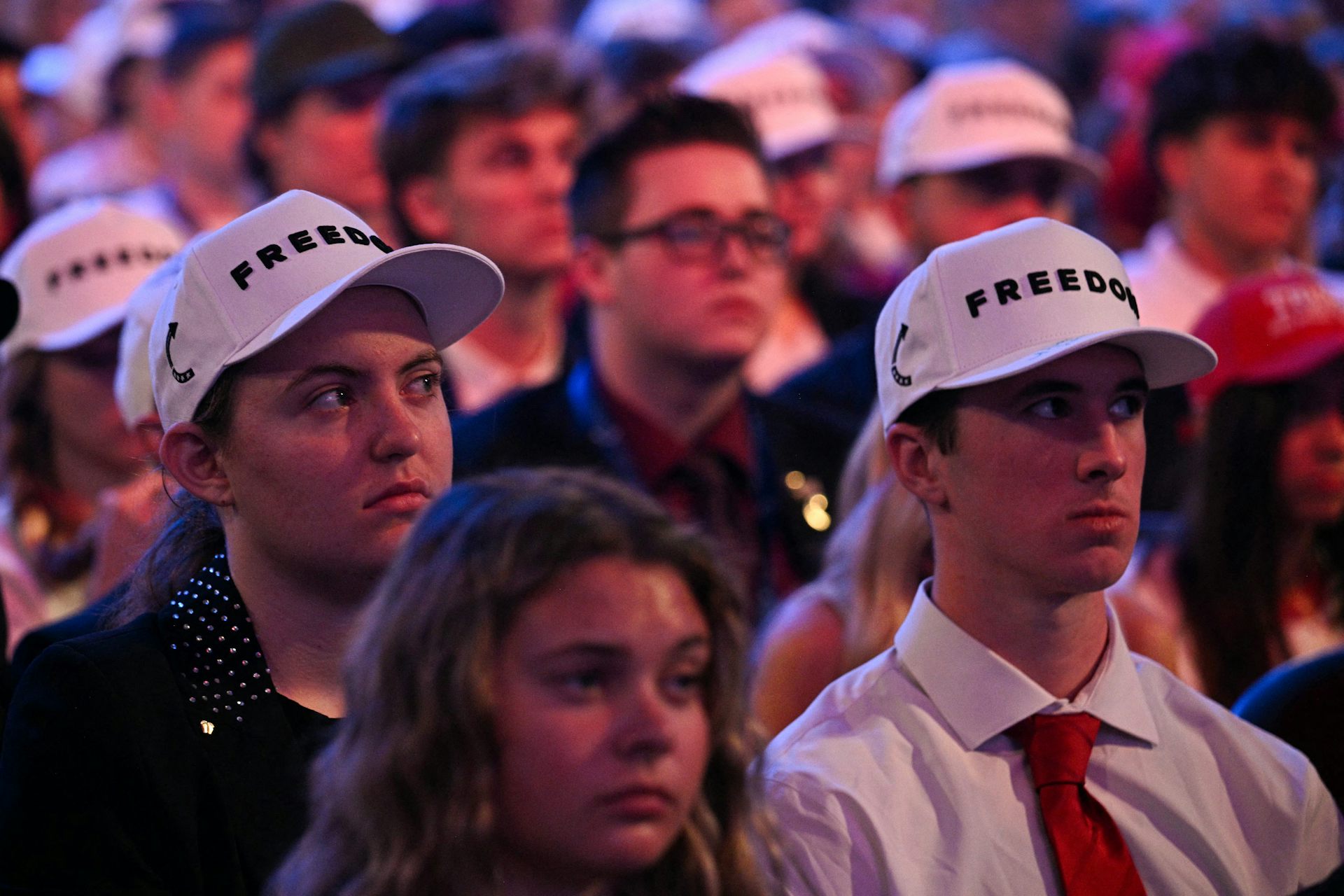 Young attendees wear hats reading freedom during a Turning Point USA event at Dream City Church in Phoenix, Arizona.