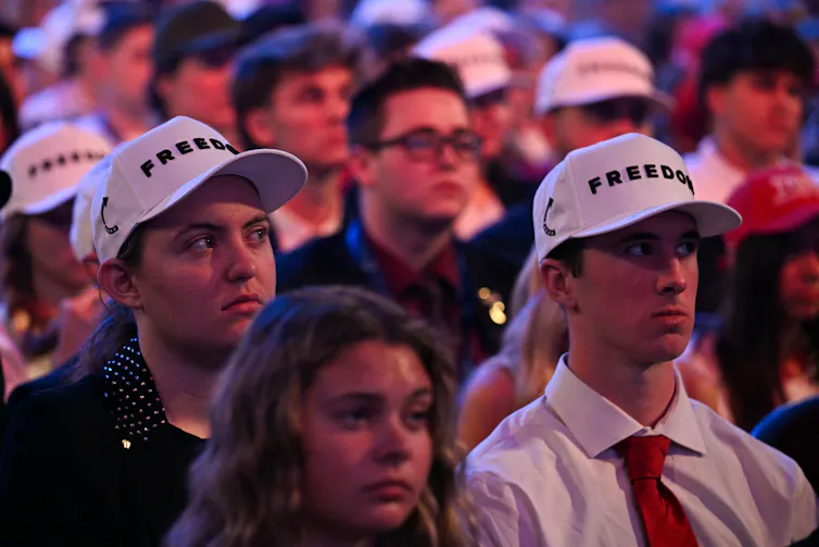 Young attendees wear hats reading freedom during a Turning Point USA event at Dream City Church in Phoenix, Arizona.