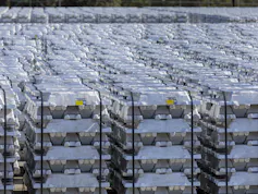 Stacked piles of aluminium stored outdoors