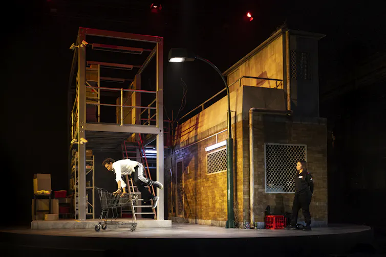 The set, a brick building and an open warehouse-like structure.