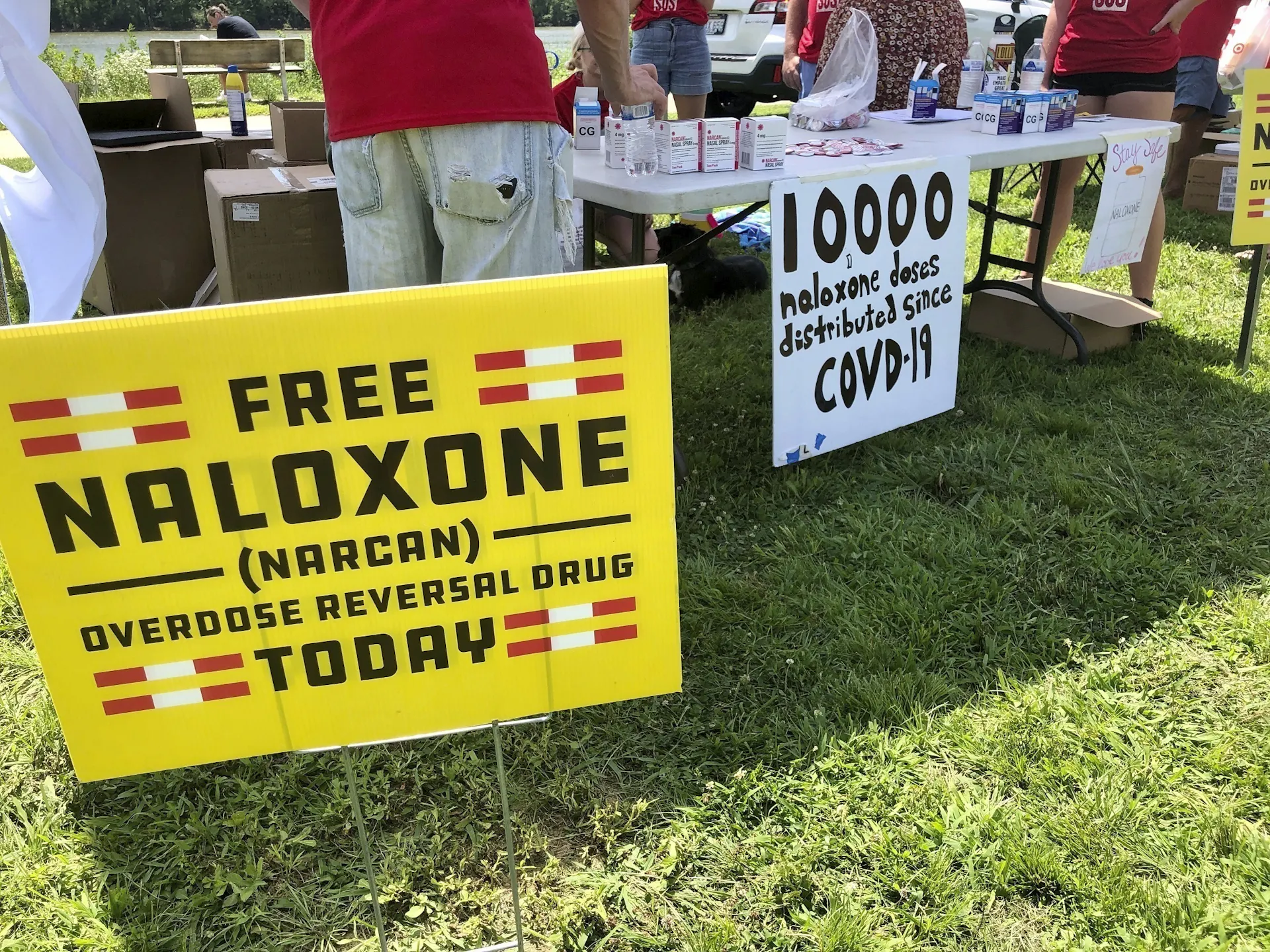 Signs are displayed at a tent during a health event in 2021 in Charleston, W.Va.