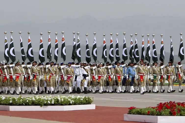 Troops march in a parade.