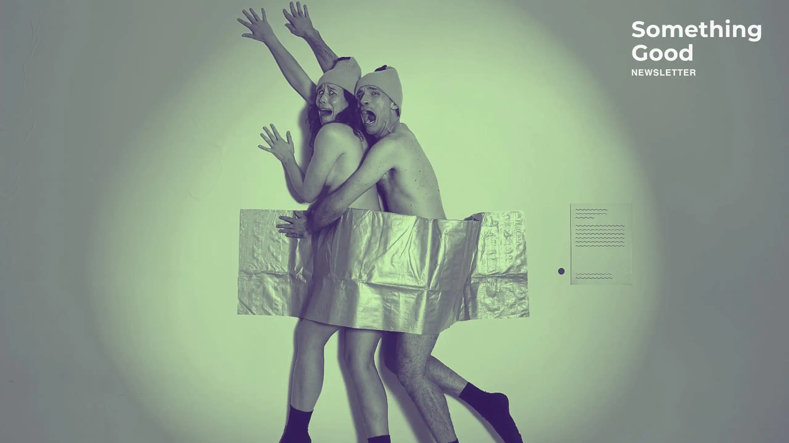 Two people dressed as bananas, stuck to a wall with duct tape.