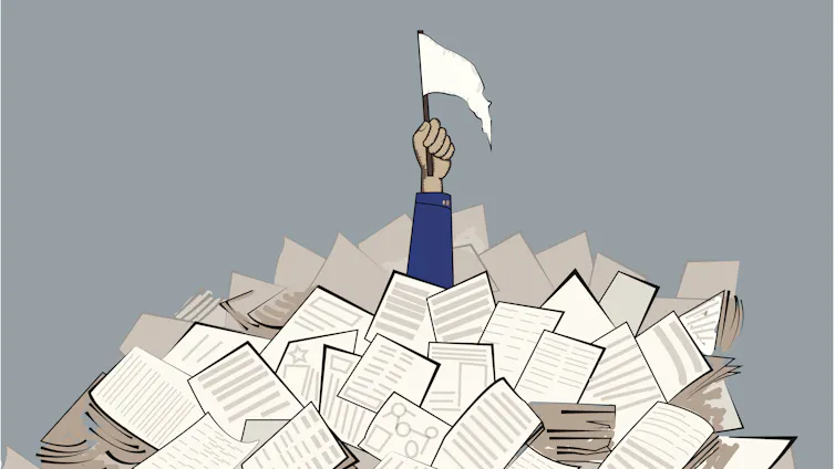An outstretched arm pokes through a pile of paper, holding a white flag signaling surrender. bankruptcy