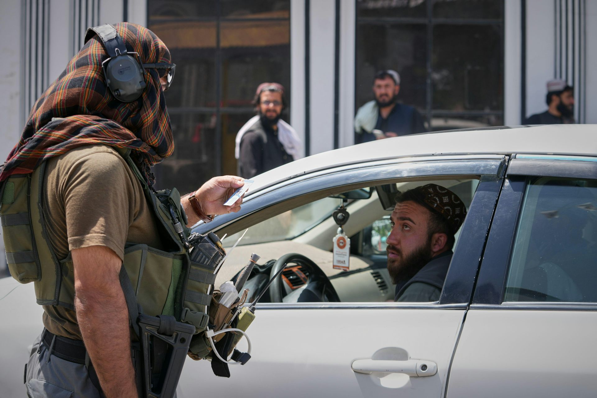 Afghan security forces check a driver's papers, Kabul, August 13 2026.